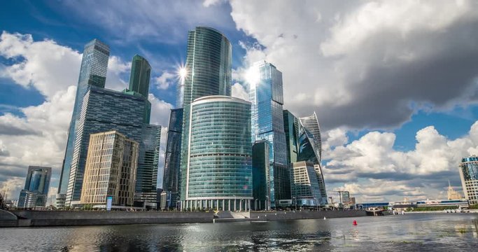 Moscow city, Russia. The main skyscrapers of the capital reflected in the Moscow River. Clouds over the city. Time laps RAW 4K