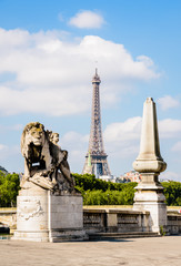 Fototapeta na wymiar The Eiffel tower in Paris, France, seen from the pont Alexandre III with a lion sculpture in the foreground.