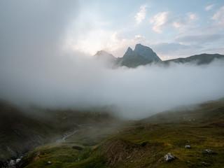 Iconic mountain of Pyrenees being covered by fog