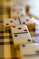 dominoes on a table with plaid mat