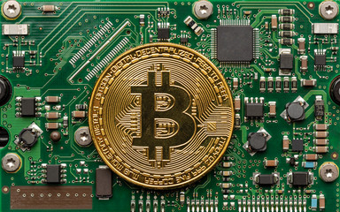 Physical bitcoin on top of a circuit board.