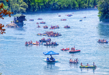 Regatta on the river Drina, launching boats and rafts down the river next interesting wooden houses...
