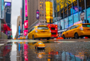Vintage old Taxi toy in New York City most popular places. Classic Yellow Cab in Manhattan and Brooklyn. The symbol of New York. Driving a taxi through Times Square.  © Aerial Film Studio