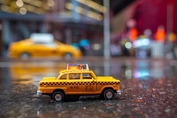 Vintage old Taxi toy in New York City most popular places. Classic Yellow Cab in Manhattan and...