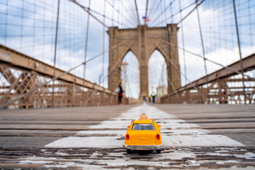 Vintage old Taxi toy in New York City most popular places. Classic Yellow Cab in Manhattan and...