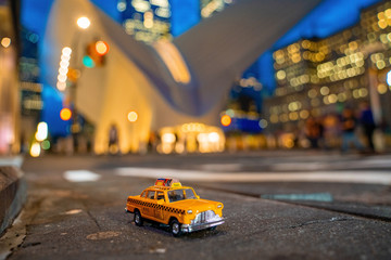 Vintage old Taxi toy in New York City most popular places. Classic Yellow Cab in Manhattan and Brooklyn. The symbol of New York. Driving a taxi through Manhattan island.  © Aerial Film Studio