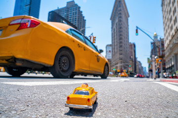 Vintage old Taxi toy in New York City most popular places. Classic Yellow Cab in Manhattan and...