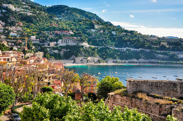 Fototapeta na wymiar Beautiful turquoise water bay with yachts and beach of Villefranche-sur-Mer. On of the most prestigious region of Côte d’Azur French Riviera near Nice.
