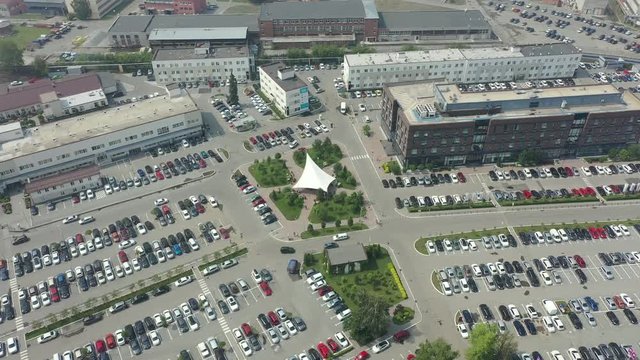 top view of the business district with office buildings and lots of cars and Parking lots. aerial 4K.