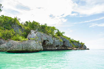 Atlantic ocean coastline .Bahia De Las Aguilas Dominican Republic. Scenic view of rocks on shore of...
