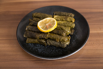 olive oil stuffed leaves on the plate with vegetable for service for restaurant concept from Turkey.