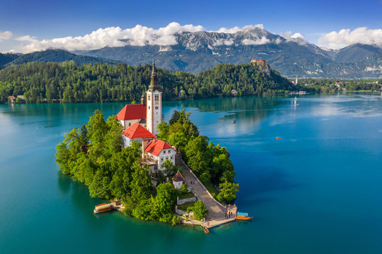Bled, Slovenia - Aerial view of beautiful Lake Bled (Blejsko Jezero) with the Pilgrimage Church of the Assumption of Maria on a small island and Bled Castle and Julian Alps at backgroud at summer time