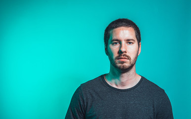 portrait of men on green background watching serious into the camera
