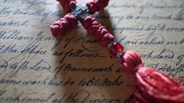 Close up of christian cross on old letter