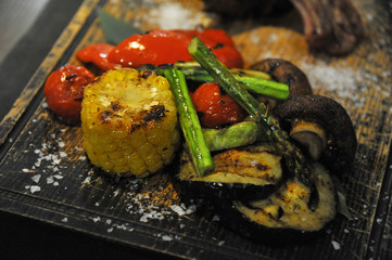 Steak is a good roast. Grilled vegetables. Peppers, corn, tomatoes. Gourmet food in the restaurant. Healthy food. Close-up. Table setting
