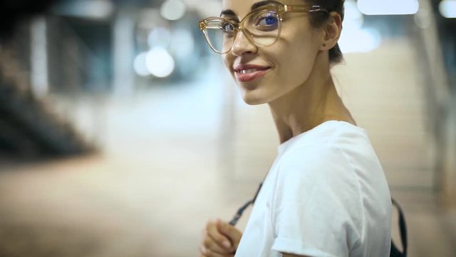 close-up portrait of young smiling fashionable beautiful woman in transparent eyewear posing outdoors. slow motion Full HD stock footage