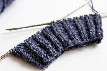 Yarn and knitting needles on white background. Handmade process