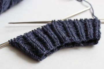 Yarn and knitting needles on white background. Handmade process