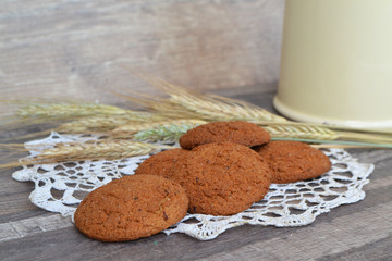 Sweet oat cookies on a napkin from a rough fabric on wooden table