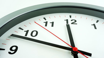 Close up Gray wall clock face beginning of time 14.45 on White background, Time concept..