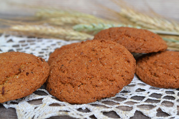 Heap of baked oat cookies on knitted napkin