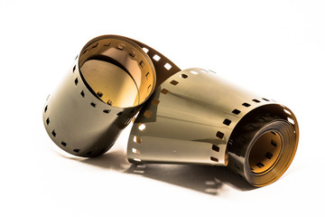 Rolled undeveloped film strip in white background