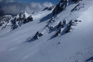 close up white snow side slope details of Jade Dragon Snow Mountain in Yunnan China. grey dark mountain rocks. exquisite fine and smooth white snow