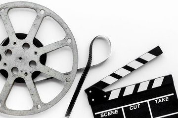 Go to the cinema with film type and clapperboard on white background top view