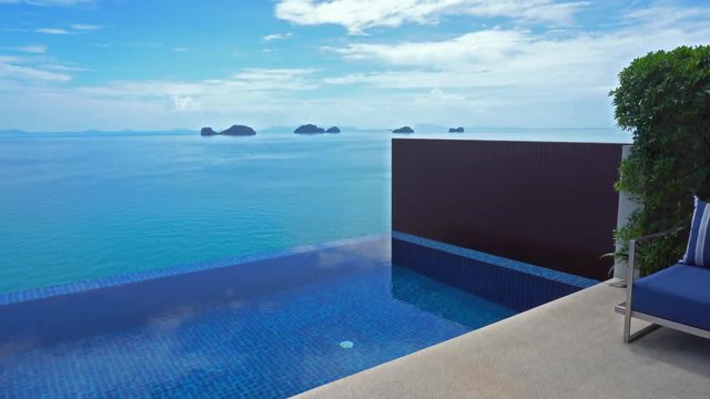 Gorgeous panning shot of an idyllic infinity pool looking out at the sea.