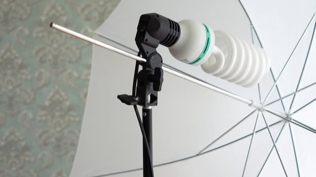 studio lighting in the form of an umbrella on the rack