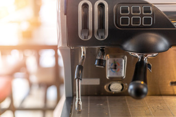 Close-Up of coffee machine in the coffee shop on morning time with sun light effect. len blur effect focus of coffee machine