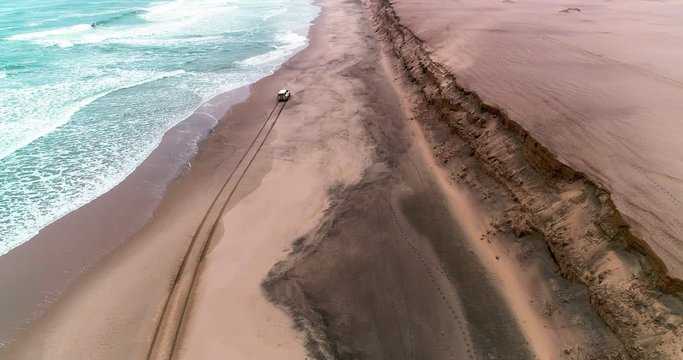Arial birds eye view of the magnificent Namibian Skeleton Coast. Driving on the beach. The unforgiving Atlantic Ocean Waves crashes onto the shore, where many ships have lost the war.