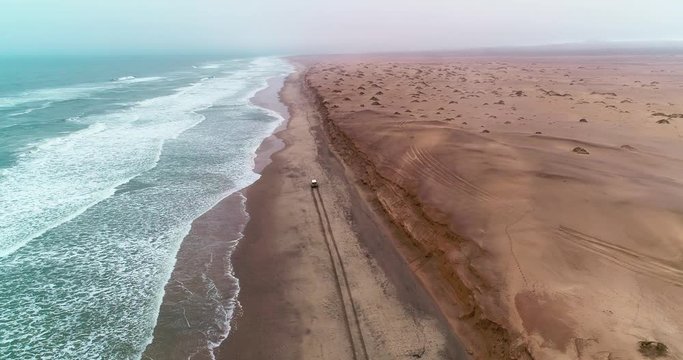 Arial birds eye view of the magnificent Namibian Skeleton Coast. Driving on the beach. The unforgiving Atlantic Ocean Waves crashes onto the shore, where many ships have lost the war.