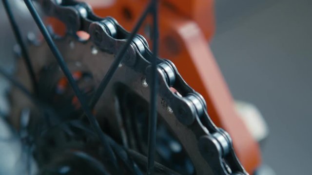 repairing wheel in bicycle's workshop, Close up shot of rotating Road Bicycle chainring gear with the chain