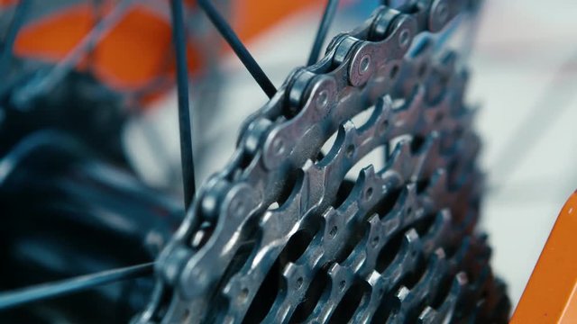 road bicycle chain ring, panning right close up shot with shallow depth of field