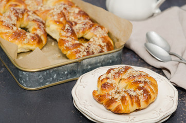 Sweet fresh baked buns with nuts in a tray