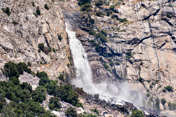View towards Wapama falls dropping along granite walls; Hetch Hetchy Reservoir area, Yosemite National Park, Sierra Nevada mountains, California