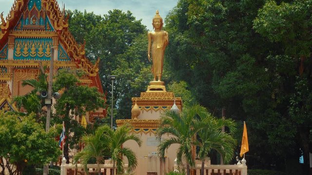 Beautiful female golden budah statue outside a typical temple in Thailand