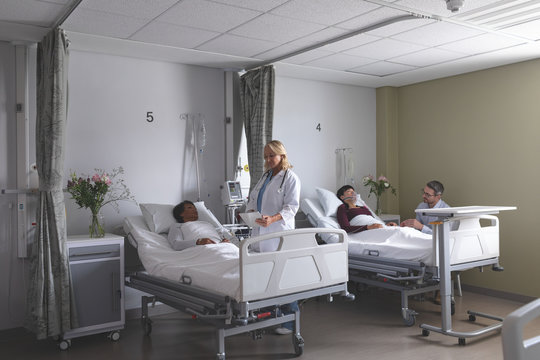Doctors interacting with patients in the ward