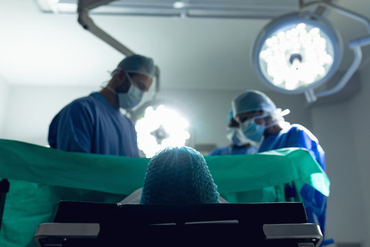 Surgeons examining pregnant woman during delivery in operating room