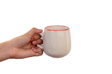 female hand holding a ceramic mug isolated on a white background