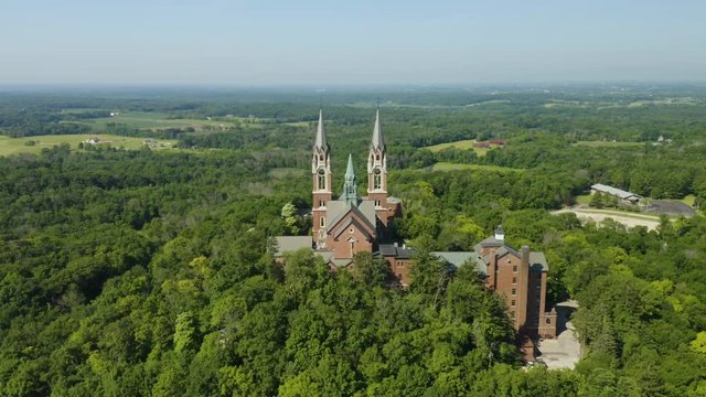 Holy Hill National Shrine of Mary, Wisconsin, USA, aerial view with flying forwards through the spires, drone footage.