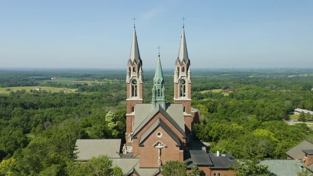 Holy Hill National Shrine of Mary, Wisconsin, USA, aerial forward fly-over through spires drone footage.