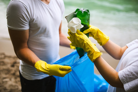 Close up image of volunteers collecting garbage