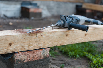 drill a hole in the board. Drill a hole in the timber.