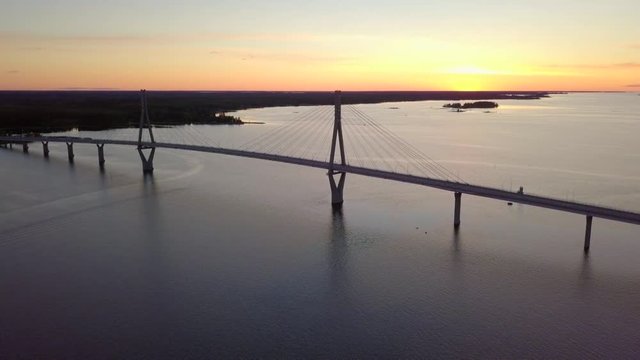 Aerial, rising, drone shot, tilting down towards the Raippaluodon silta bridge, at sunset, in the Kvarken archipelago, on a sunny, summer evening, in,Vaasa, Ostrobothnia, Finland