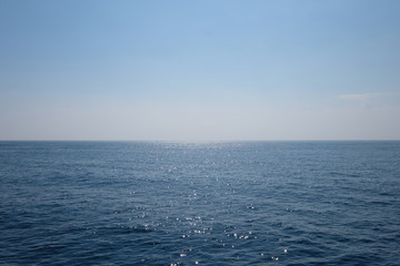 wide deep blue sea horizon. peaceful ocean with sunlight reflection. simplicity.