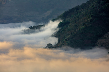 Abstract photograph above the clouds, sea of clouds effect, flying through the sky, aerial view, white puffy clouds and blue sky. Low pressure front atmospheric effect, cloudscape, cloudy weather