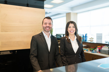 Confident Clerks Working At Reception Area