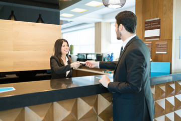 Professional Confirming Reservation At Front Desk